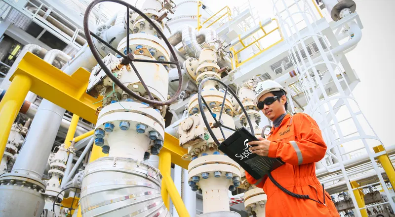 Systel engineer reviewing compressed-air readings on the plant floor
